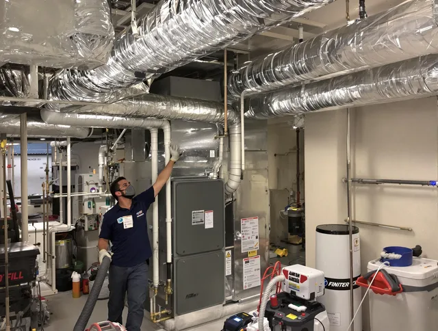 Ashland Air Duct Cleaning specialist performing thorough furnace duct cleaning in a Ashland residence