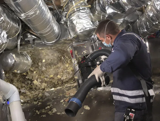 Ashland Air Duct Cleaning specialist operating negative pressure cleaning equipment for thorough duct maintenance in Ashland